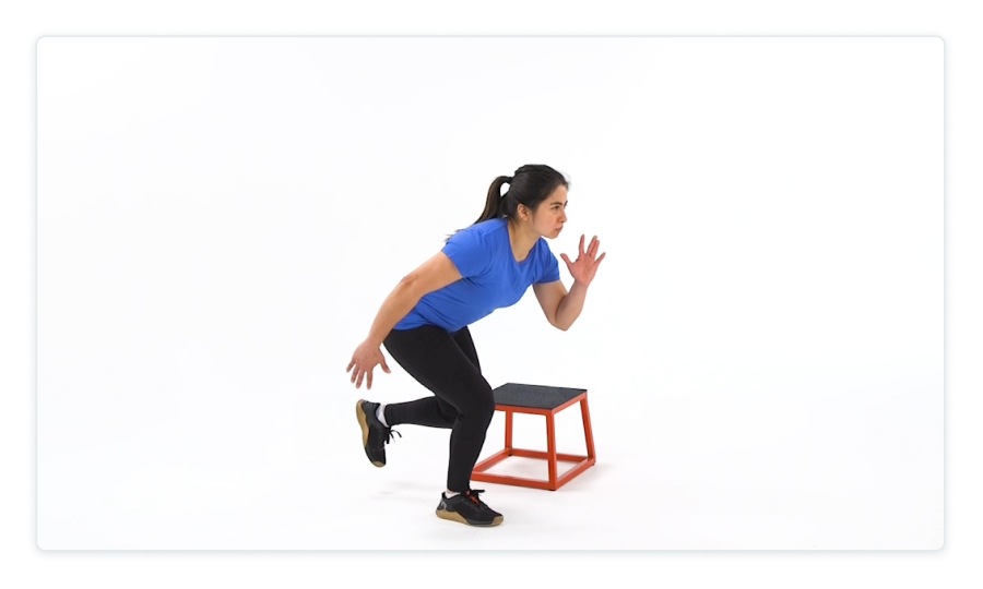 A person in a blue shirt and black pants on a white background, doing an exercise.